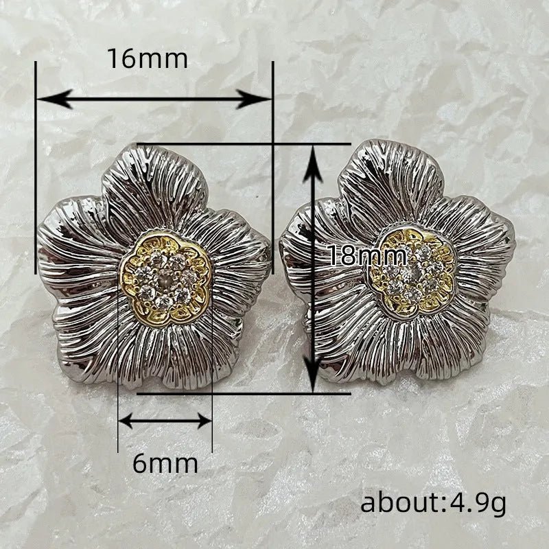 Close-up of retro textured gardenia stud earrings in two-tone copper with floral petal detail.