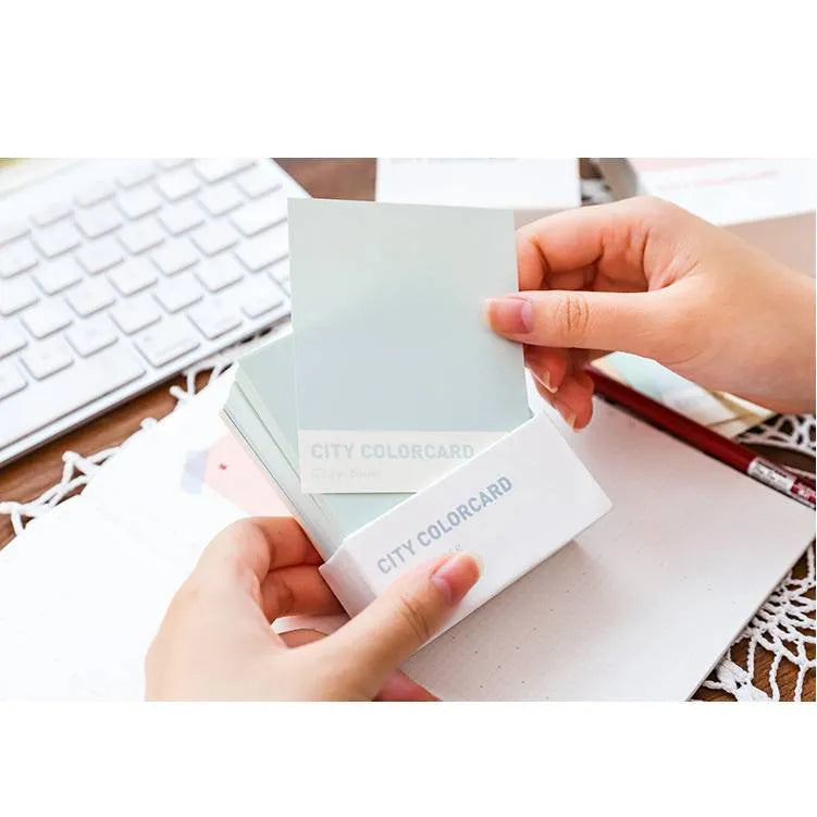 Set of four rectangular 75x95mm paper memo notes with different cityscape designs, showing no adhesive backing.