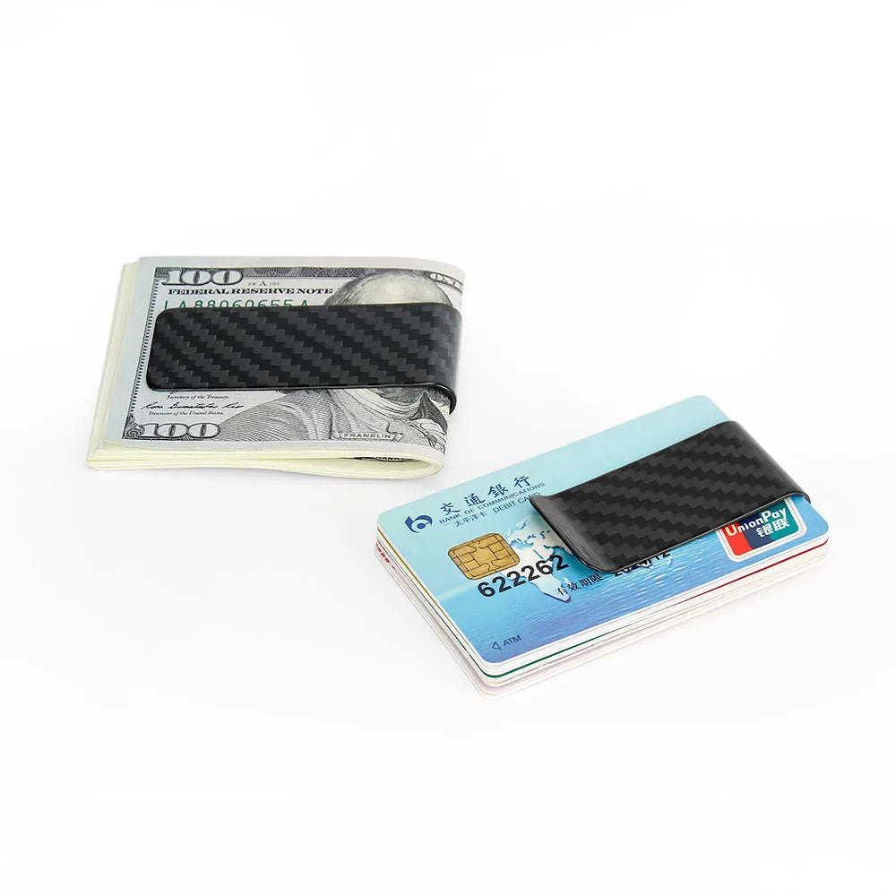 Black glossy striped carbon fibre money clip on a flat surface showing its slim profile and textured pattern