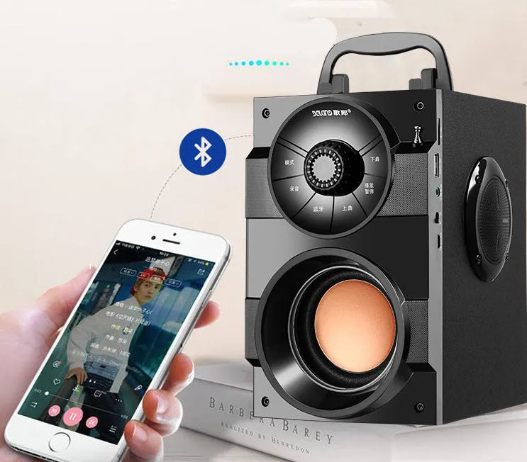 Black portable mini audio system with subwoofer and 3.5mm audio cable.