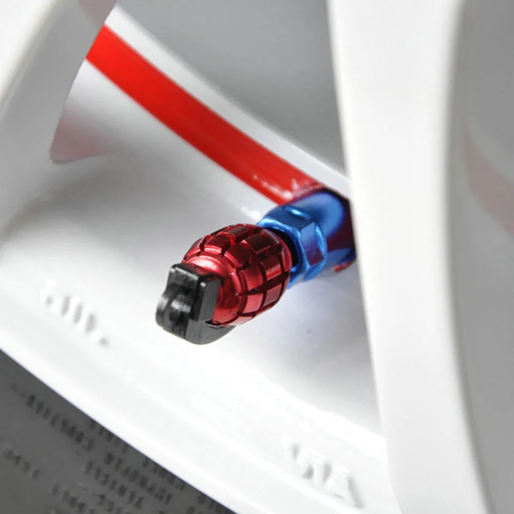 Two car tyre valve caps in red, blue, and gold colours on a white background