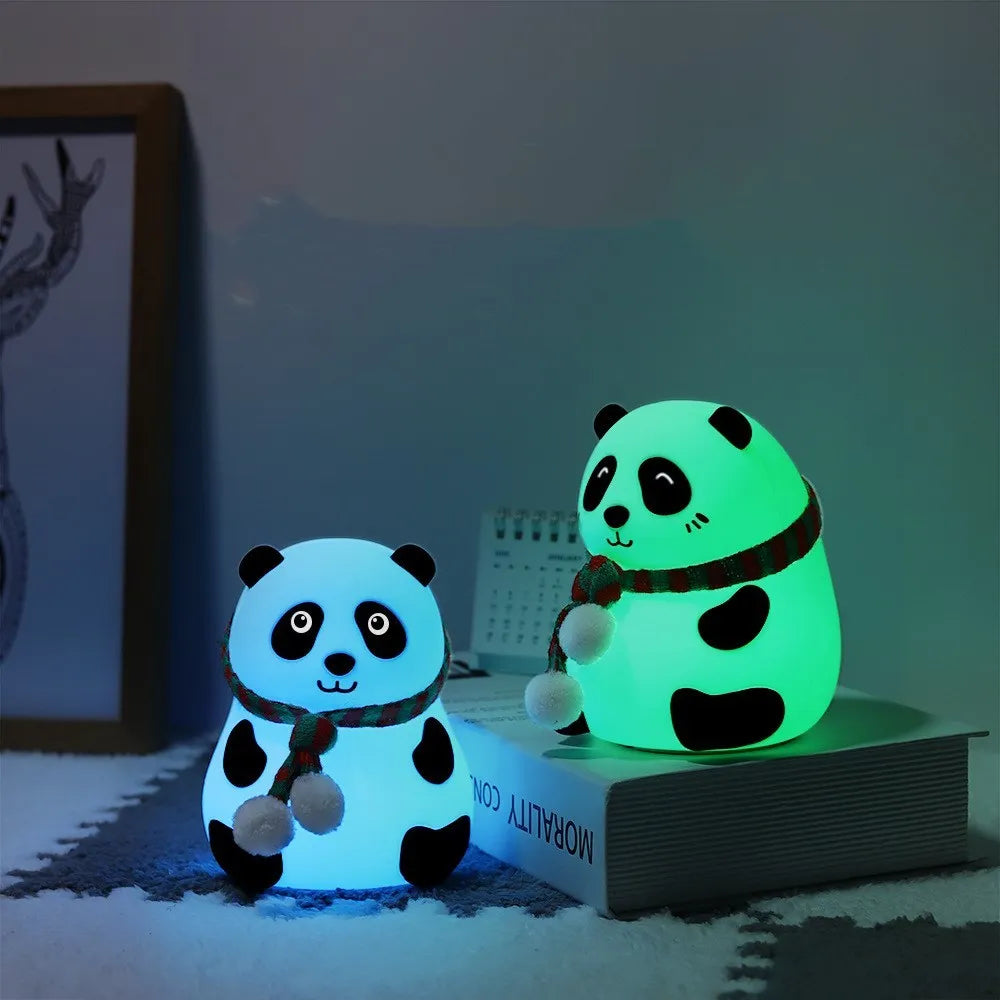 Panda-shaped silicone night light with USB cable on a table.