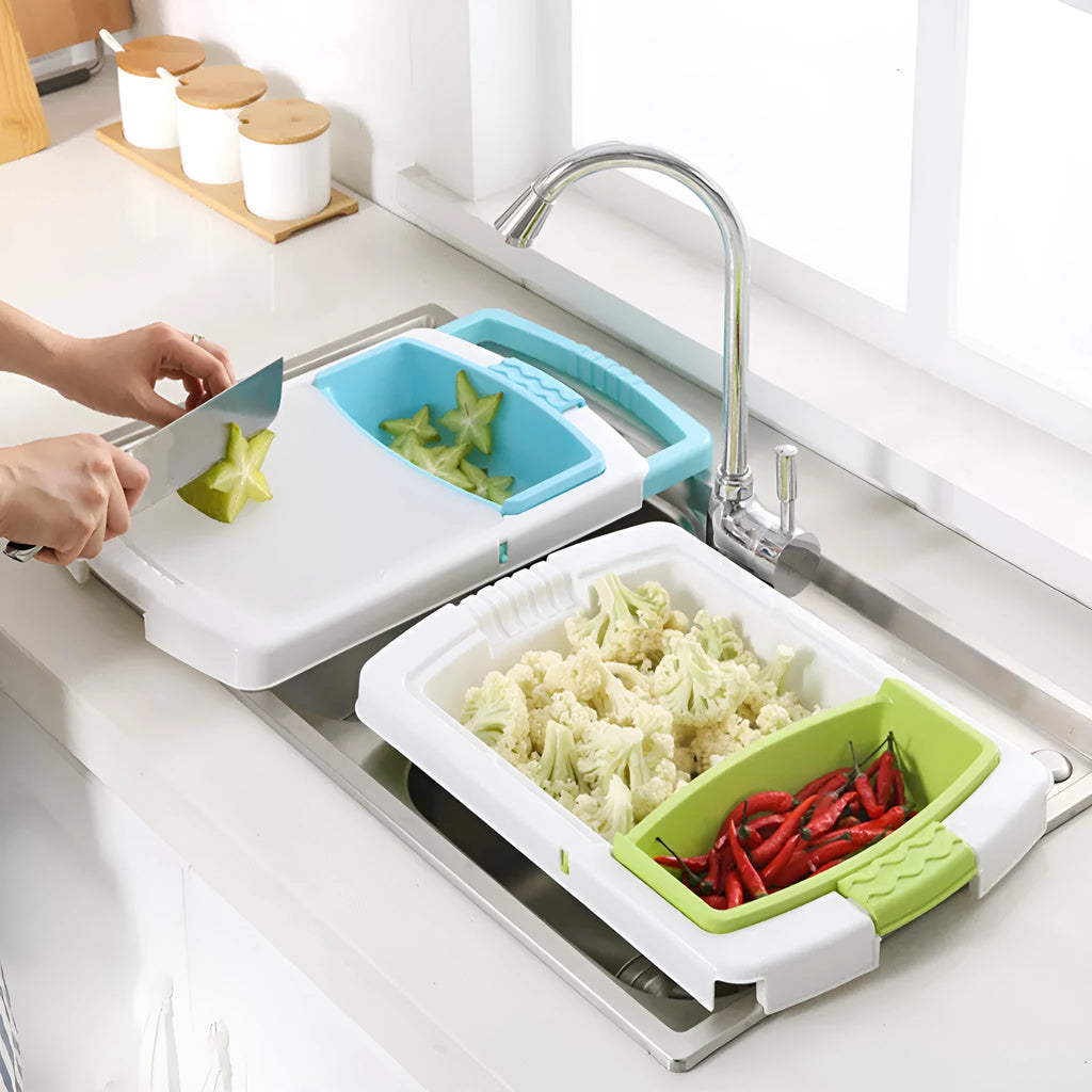 Green sink-mounted kitchen cutting board with drain holes and a storage trough for vegetables.