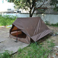 Brown or white A-line pole-free cabin tent for 2-3 people with hiking cane setup.