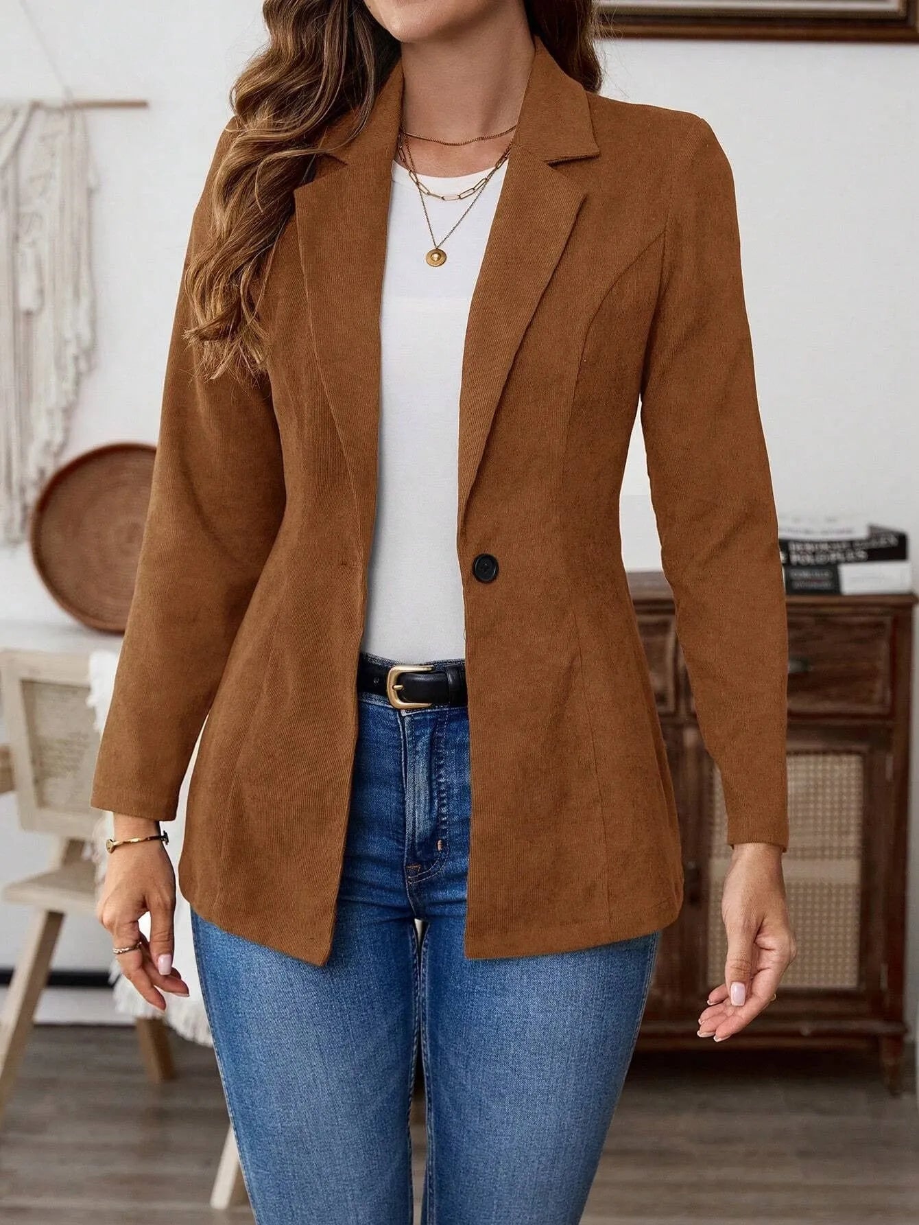 Brown single-breasted leisure suit coat with lapel collar and long sleeves laid flat.