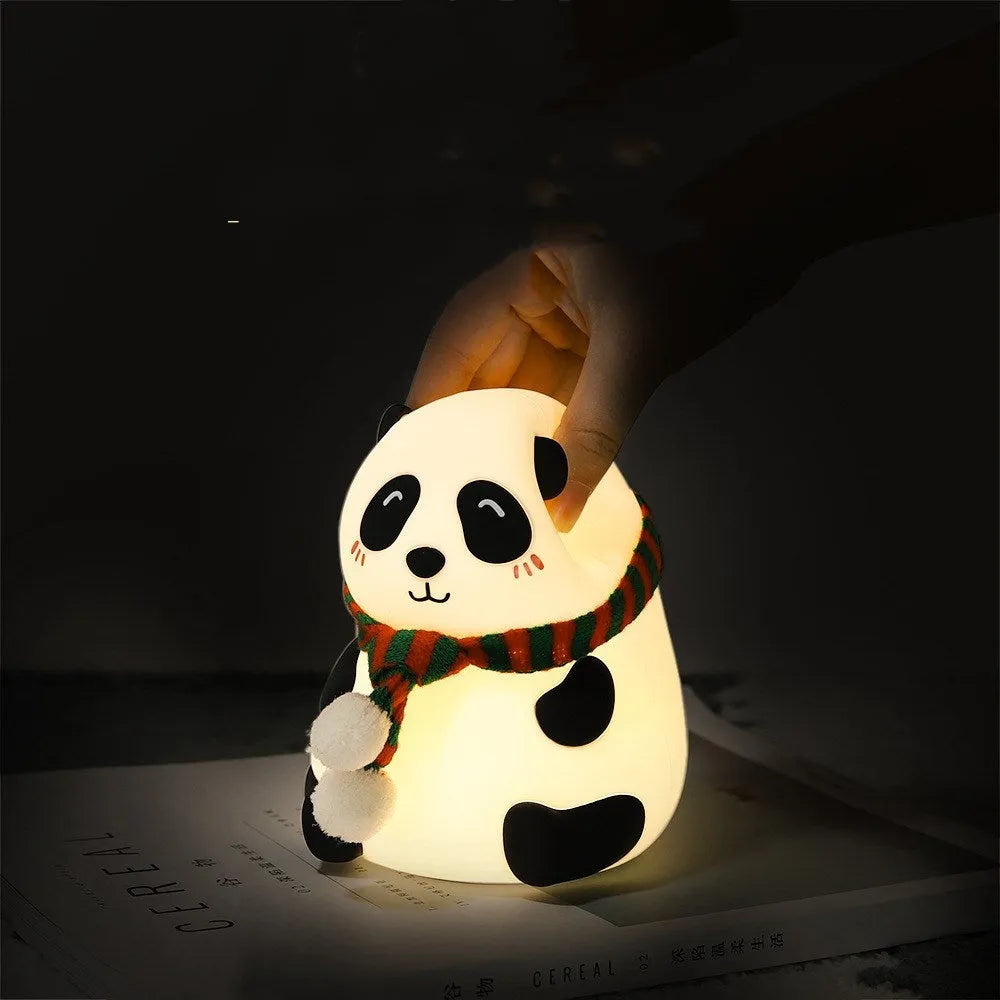 Panda-shaped silicone night light with USB cable on a table.