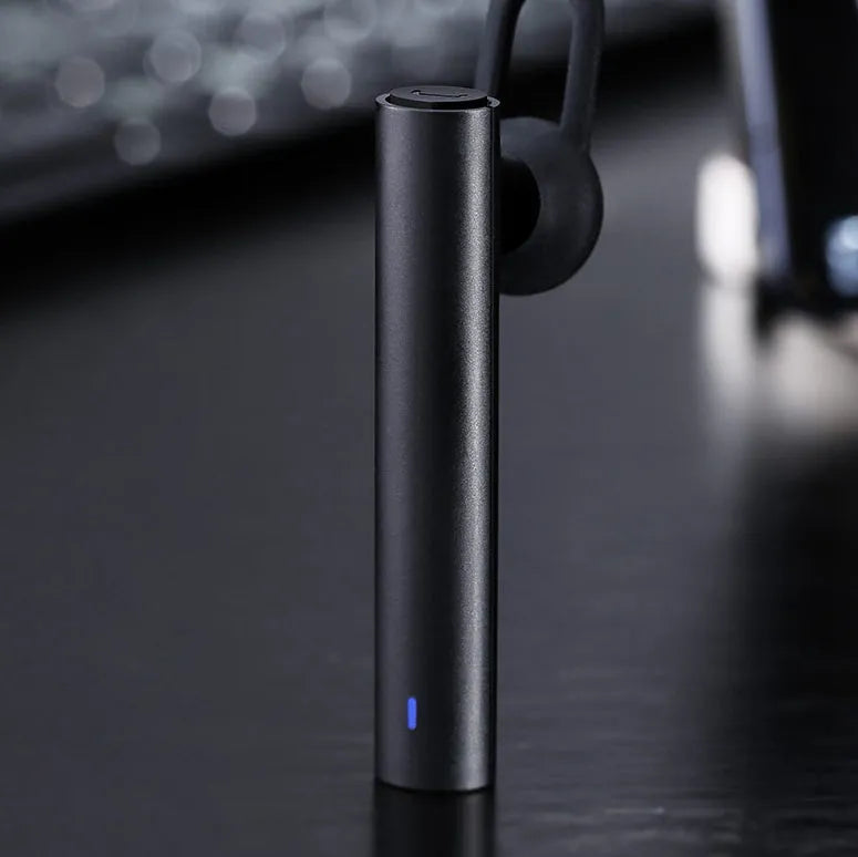 Compact black and white wireless Bluetooth V4.1 headset earpiece showing scale.
