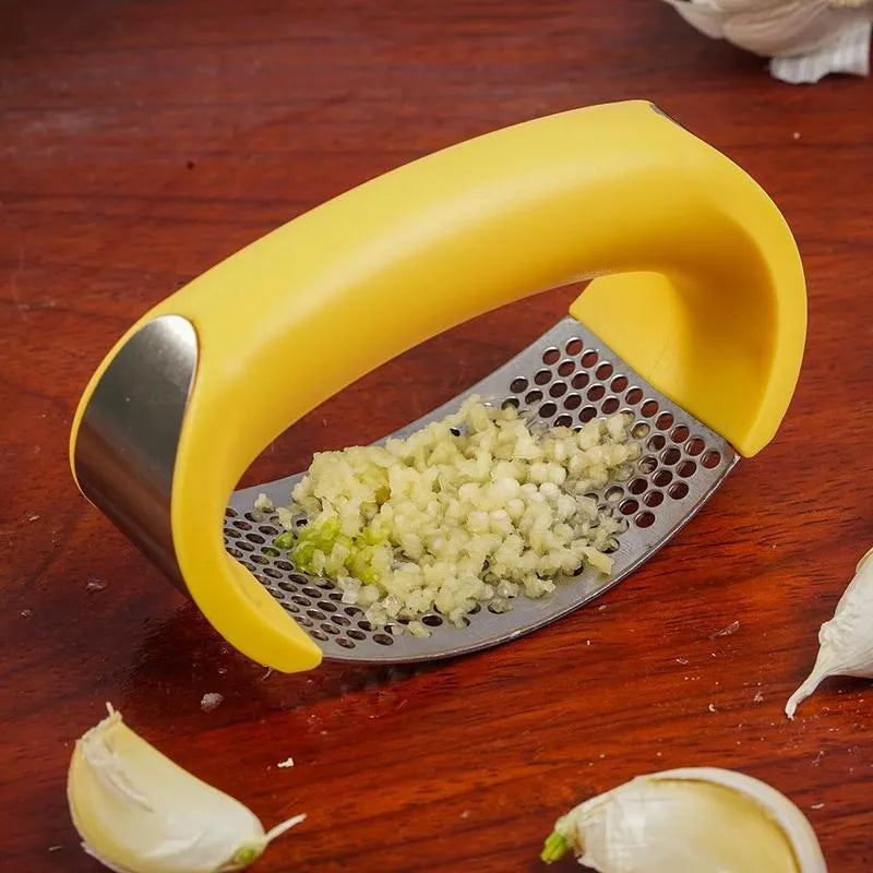 A stainless steel garlic press with a curved design and non-slip ergonomic handle.