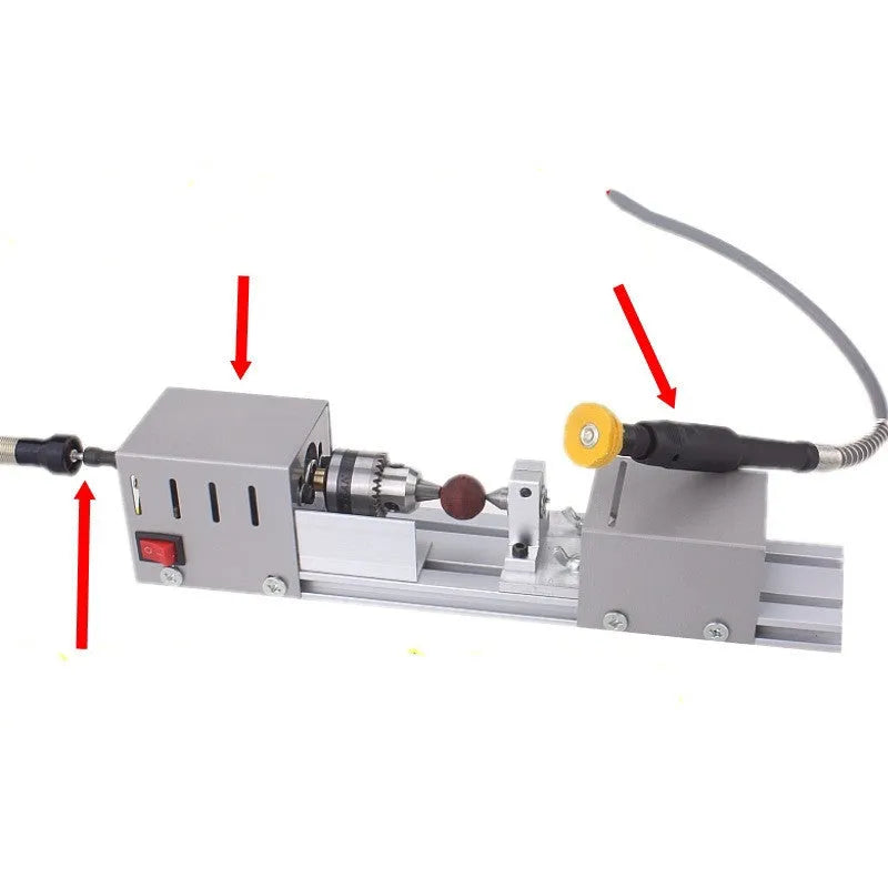 Silver metal mini manual woodworking lathe with tools on a workbench