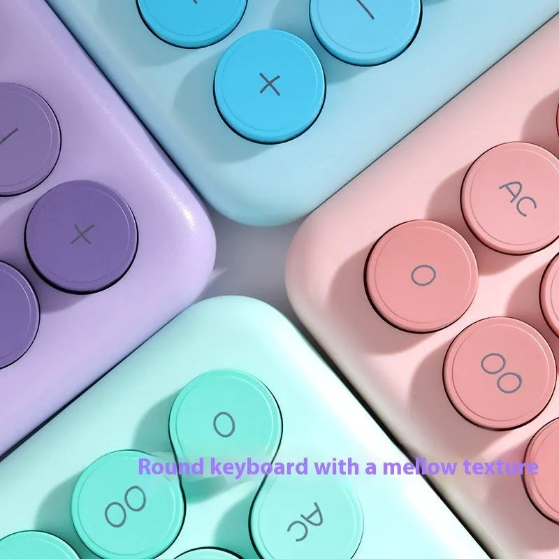 Dopamine gradient colour desk calculator in violet, pink, blue, and green on a white desk.