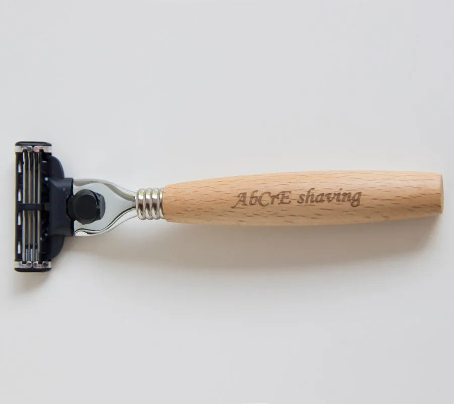 Men's manual shaving set with beech handle razor, bristle brush, stainless steel soap bowl, and metal stand