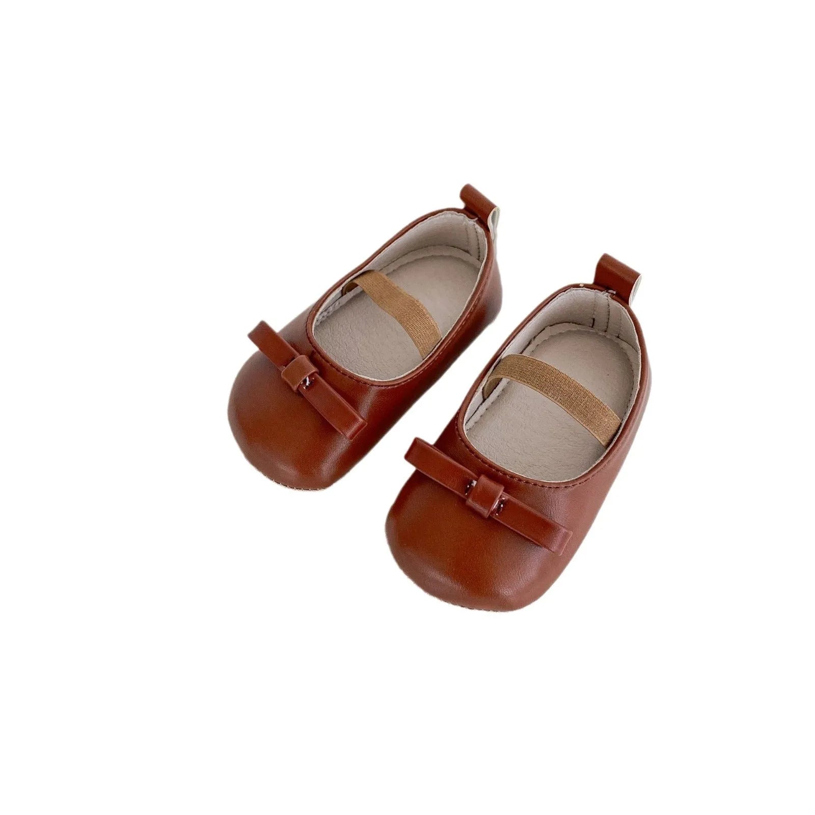 Women's soft non-slip PU low top baby shoes in black with bow detail on white background