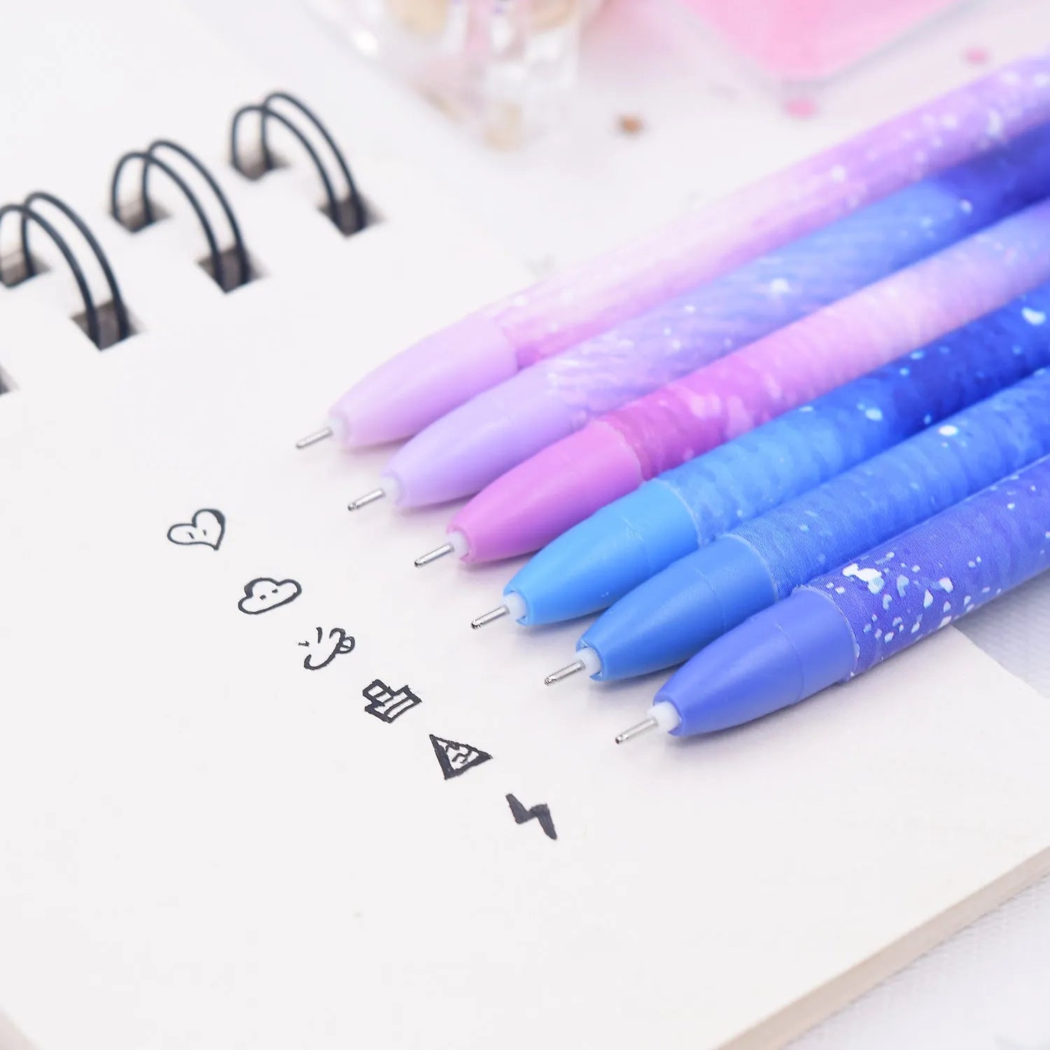 Box containing 12 colourful Constellation quick-drying gel pens for office and writing tasks.