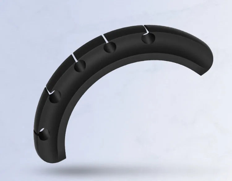 Black organic silicone desktop cable manager clips holding USB cables on a desk