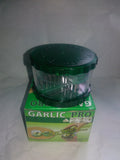 Green transparent plastic garlic peeler with silicone roller for removing skins.