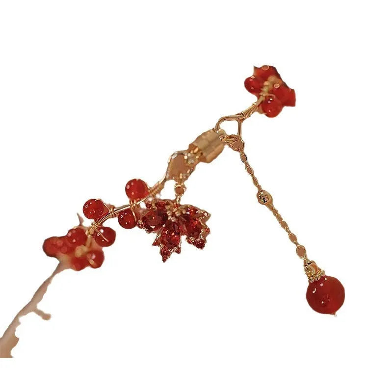 Red Chinese style magnetic bracelet with maple leaf and ginkgo leaf designs on alloy band