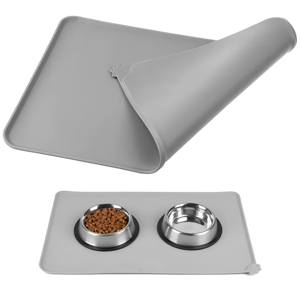 Black silicone dog food mat measuring 47 by 30 centimetres with non-slip surface and raised edges.