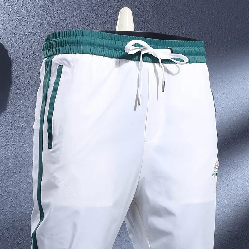 Ice silk breathable stretch ankle-tied skinny sports trousers for men in black striped pattern