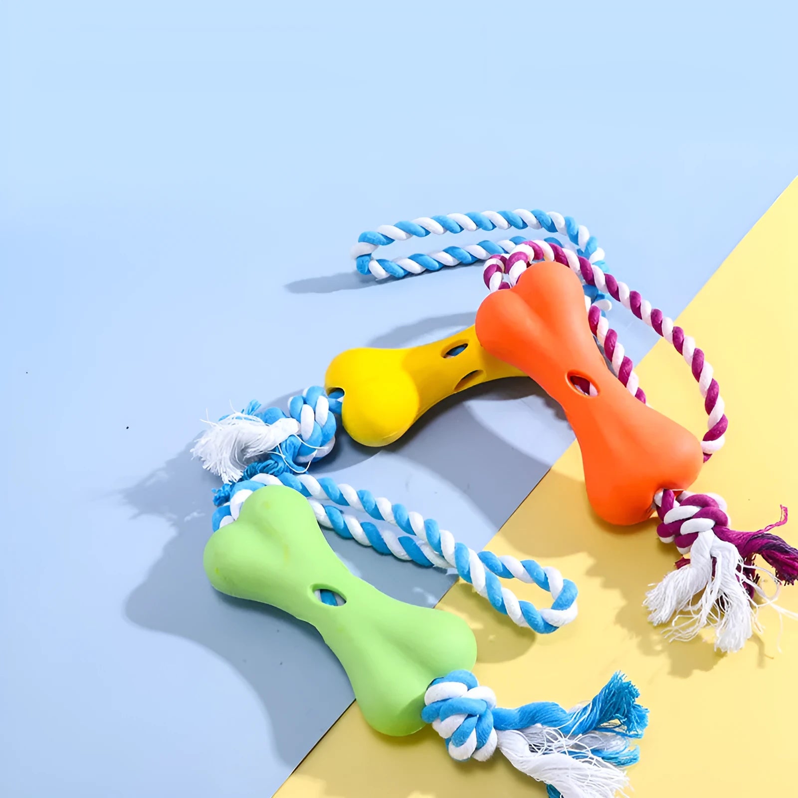 Green porous leaking bone dog toy with rope knot construction for chewing and treat stuffing