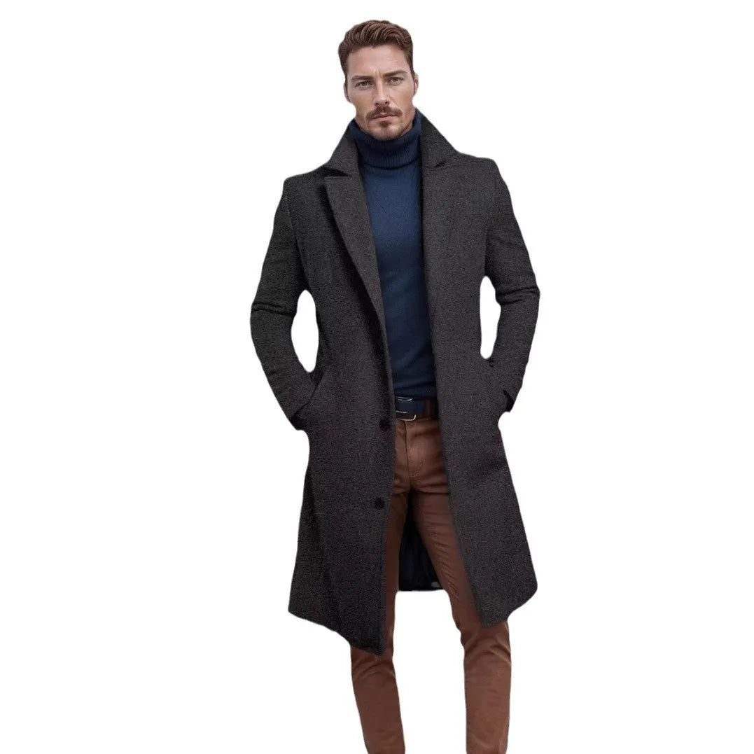 Men's mid-length solid colour woolen coat in dark gray, side view, showing thick fabric and side seam pocket.