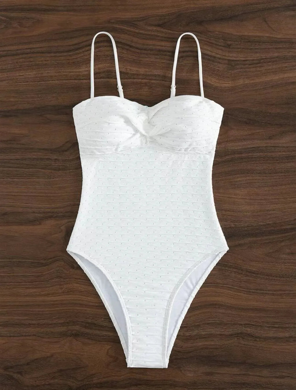 White women's one-piece swimsuit with sling style and brief cut design on mannequin