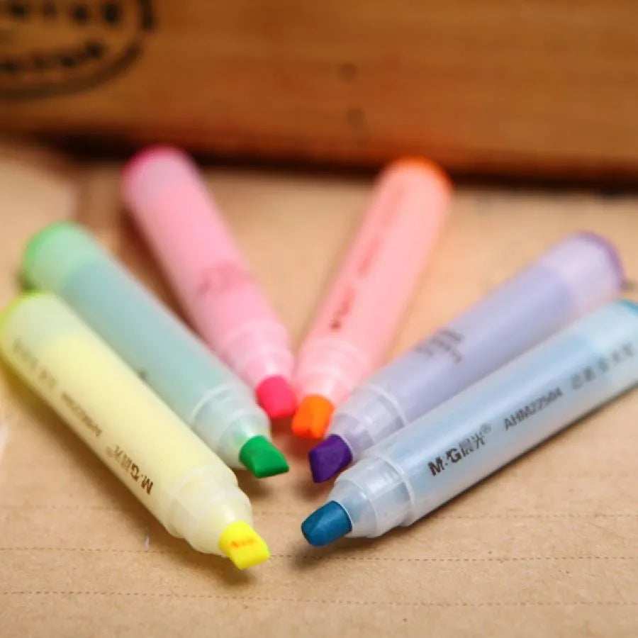 Six plastic highlighter pens with oblique shape and chisel tips in multiple colours for text marking