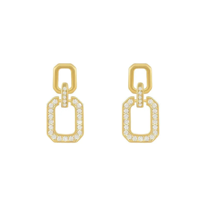 Pair of geometric alloy ear studs with electroplated finish on white background