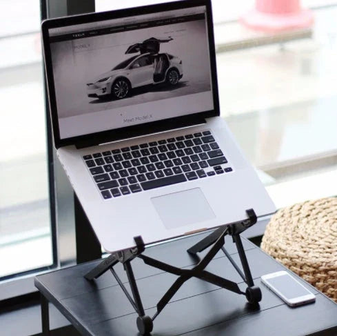 Adjustable desktop computer stand with sleek and modern design, supporting a variety of devices for improved ergonomics and workspace organization.