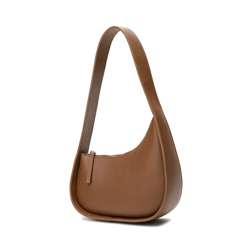 Half moon shaped leather ladies handbag with wide shoulder strap in small size