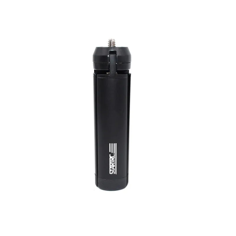 Silver aluminium smartphone bracket for tripod mounting next to a mobile phone.