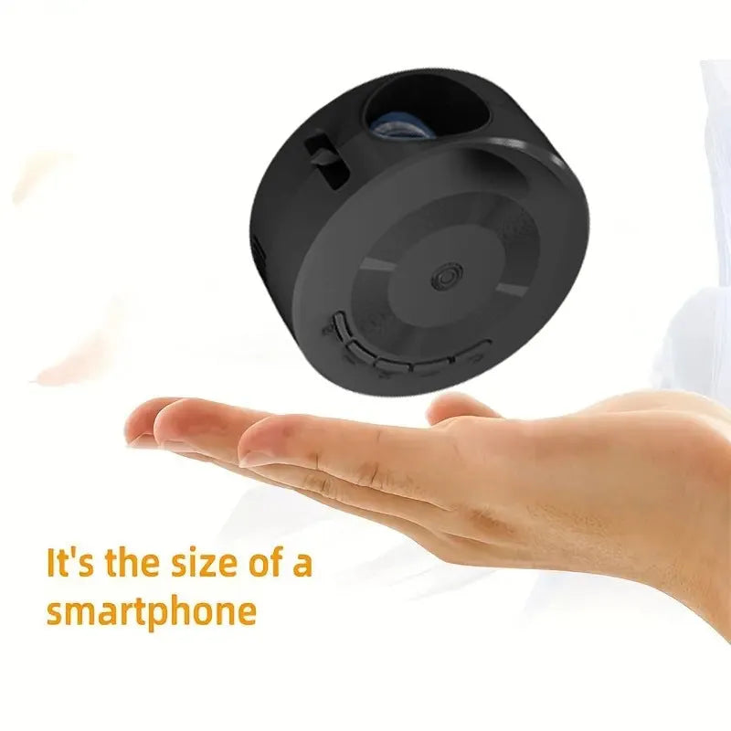Black portable 1080p wired mobile projector with USB power cable on a surface