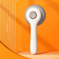 Blue and white self-cleaning slicker brush for grooming cats and dogs to remove loose fur.