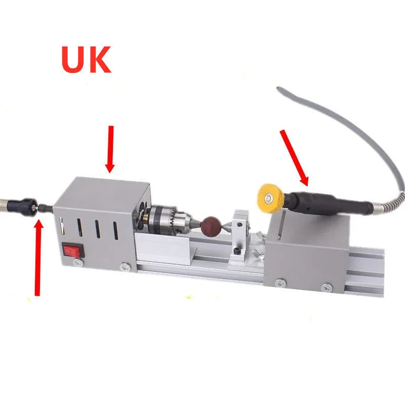 Silver metal mini manual woodworking lathe with tools on a workbench