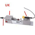 Silver metal mini manual woodworking lathe with tools on a workbench