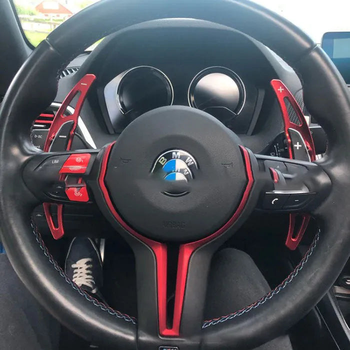 Pair of BMW M paddle shift extenders in black with 3M adhesive and screws