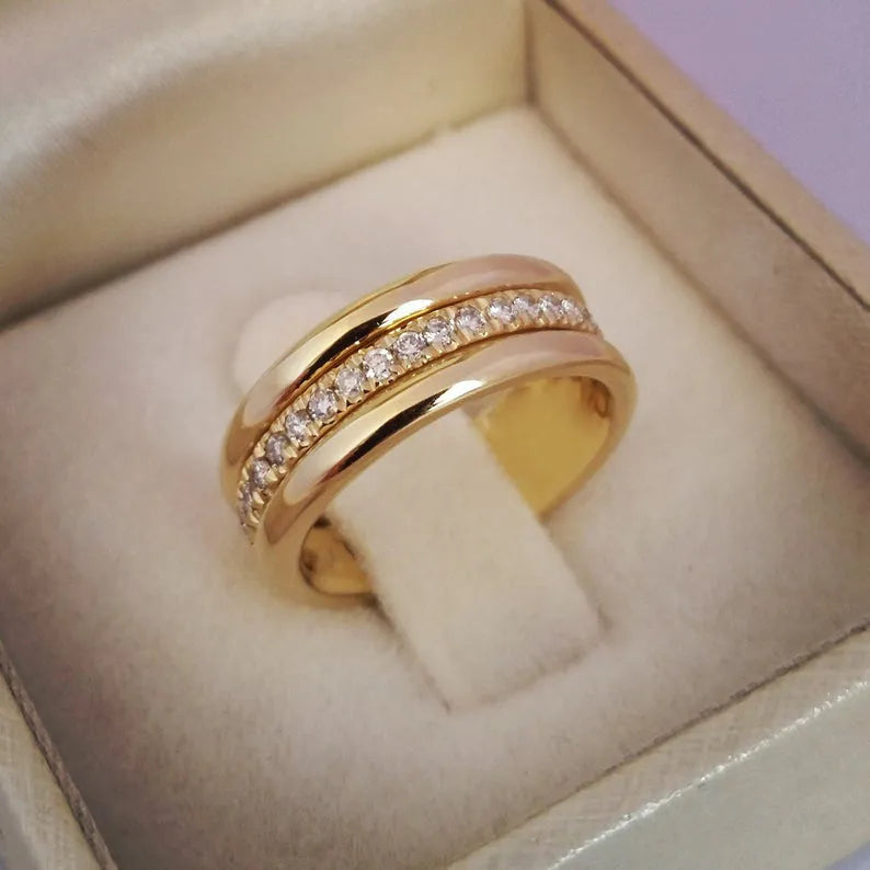 Gold-plated copper geometric ring with inlaid zircon on white background