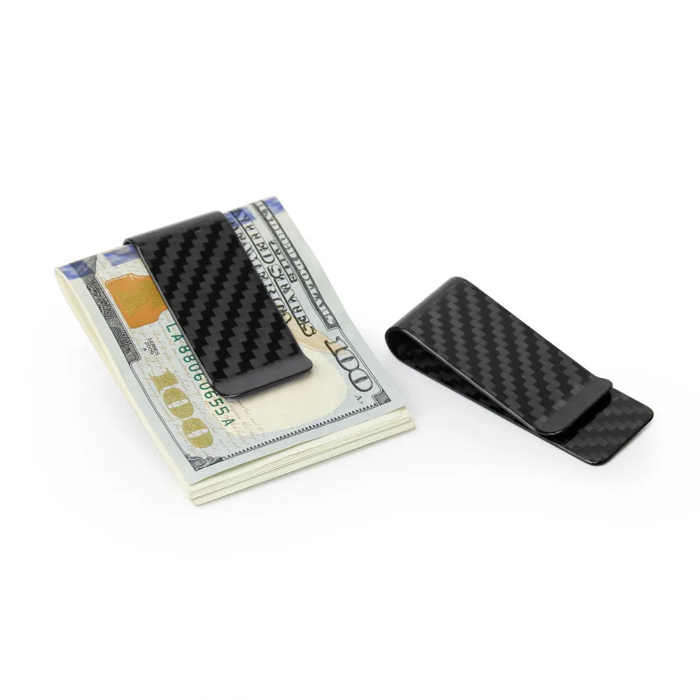 Black glossy striped carbon fibre money clip on a flat surface showing its slim profile and textured pattern
