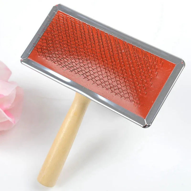 Red pet needle comb dog grooming comb with wooden handle and stainless steel plate on a neutral background