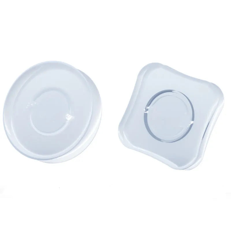 Transparent reusable nano gel adhesive pads in circular and square shapes on a smooth surface