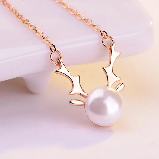Small elk pearl pendant in copper with gold finish, front view against white background