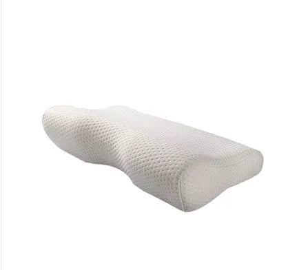Blue butterfly-shaped memory foam cervical pillow on a bed.