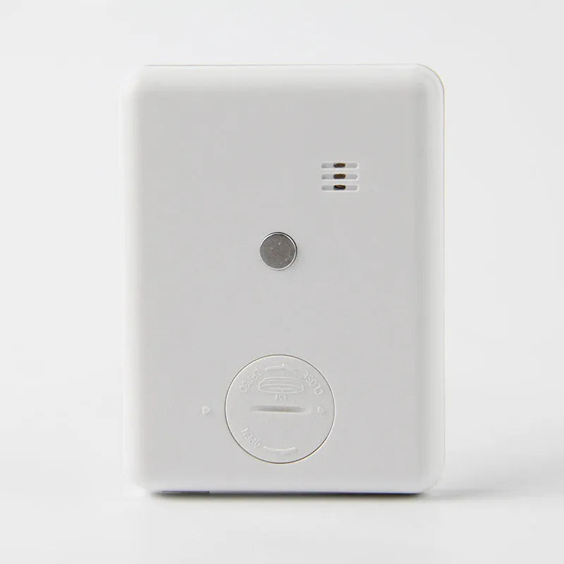 Black and white digital kitchen timer with magnetic strip on back and LCD display.