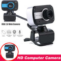 Blue mini USB webcam with rotating base on a laptop screen.