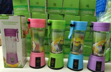 Pink portable USB blender with six blades and a 380ml cup on a kitchen counter.