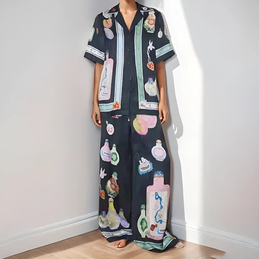 Black women's casual two-piece set with cartoon print, featuring cardigan and matching pants.