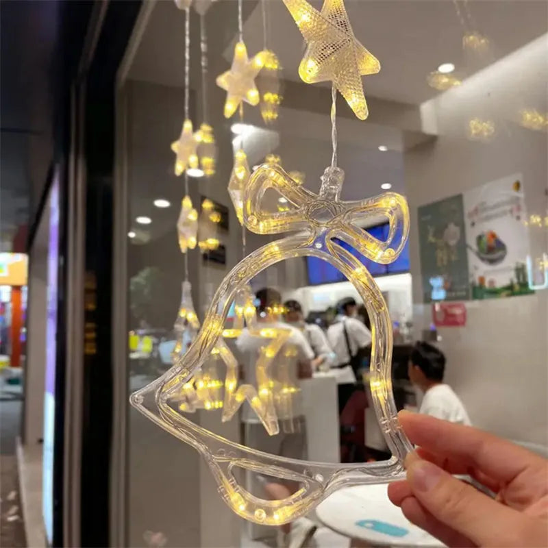 Three Christmas LED pendant lights with suction cups showing star, tree, and snowflake designs