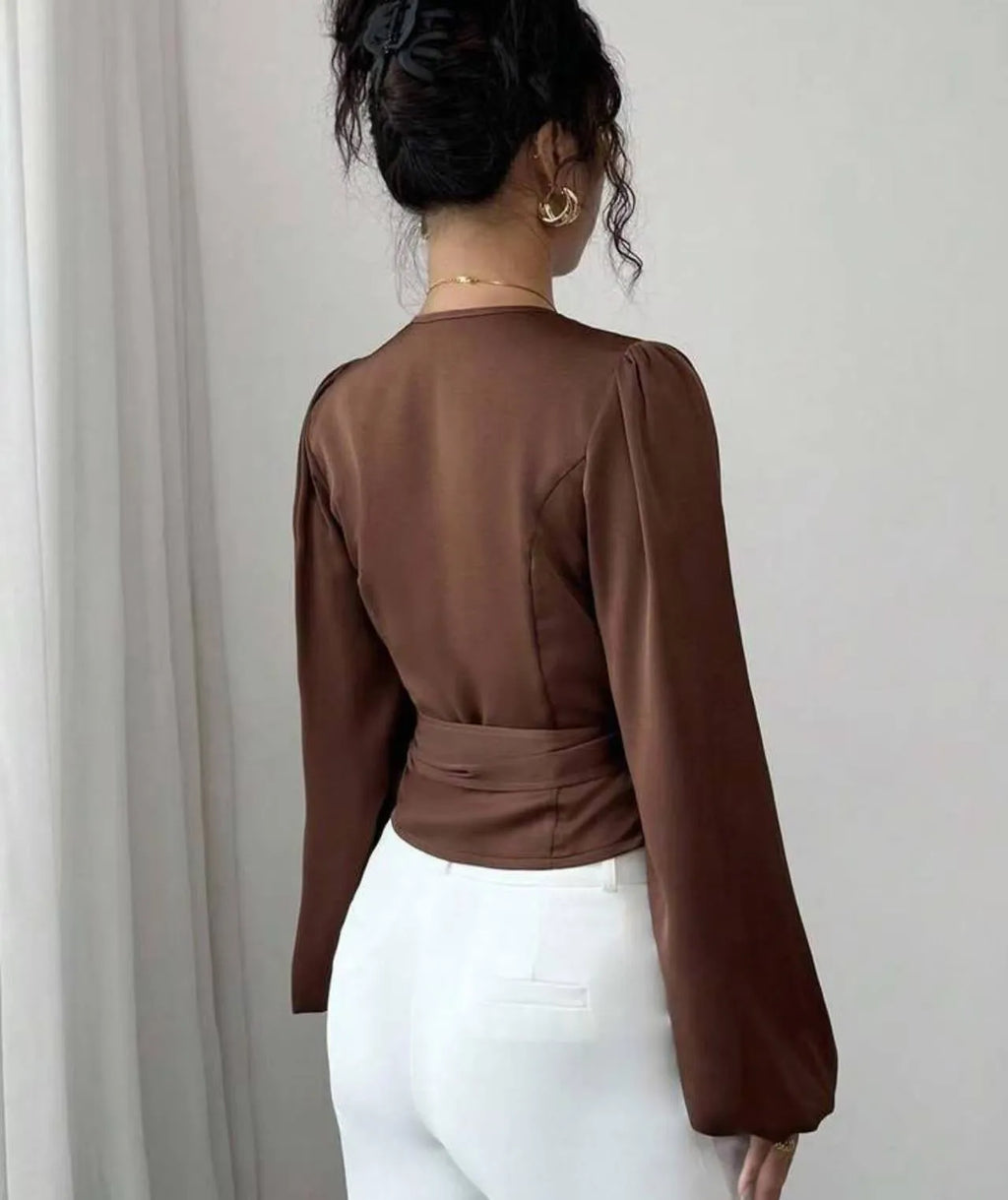 Brown long-sleeved waist-cinching shirt with ribbon detail on a female model