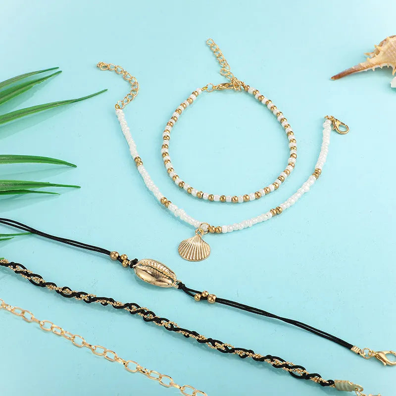 Five-piece gold tone anklet set with braided, shell and geometric ethnic style anklets for women