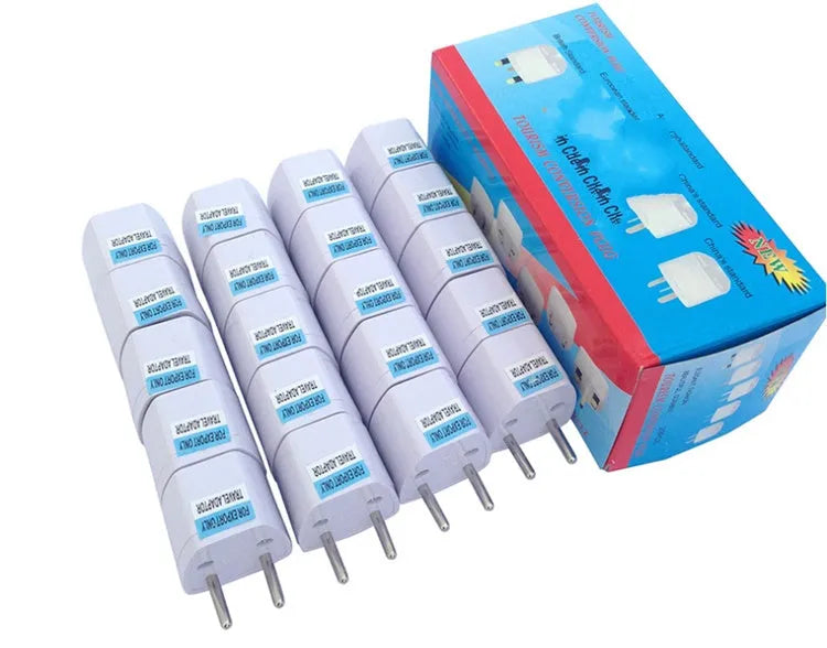 White universal travel adapter showing compatibility with AU, EU, UK, and US plug types.