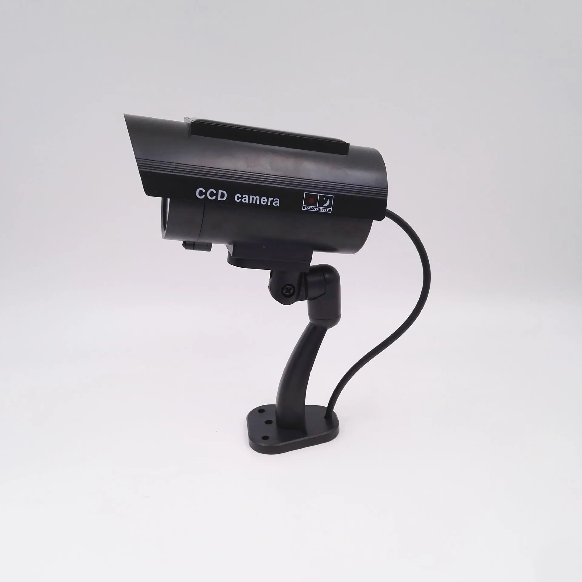 Black plastic solar-powered fake gun security camera with visible solar panel and spot light.